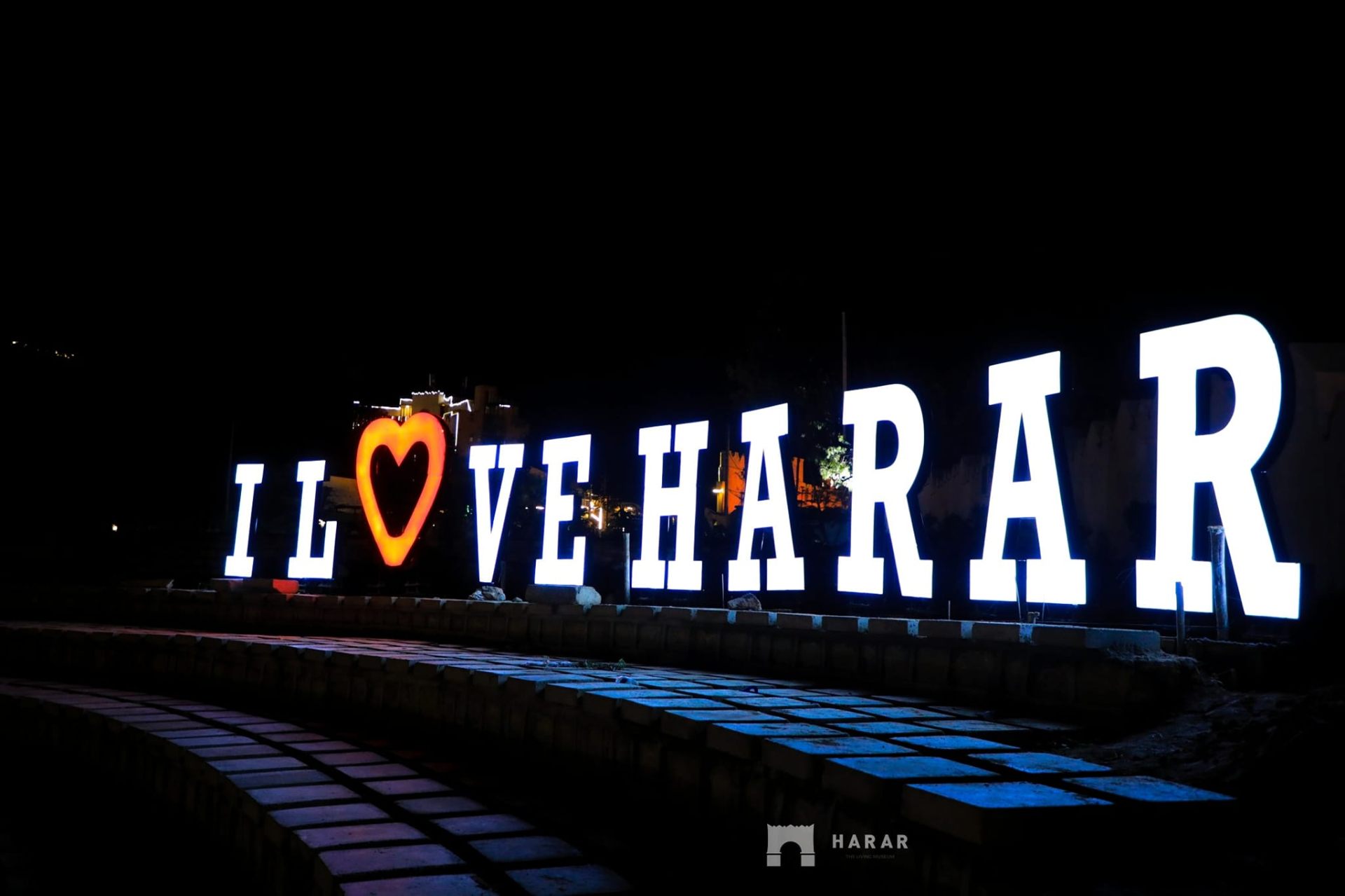 The illuminated I Love Harar landmark at night