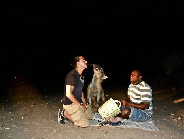 Visitors gathered in the lantern light around the handler